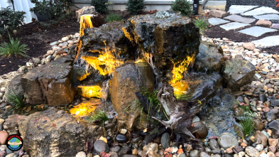 Illuminated waterfall cascade in a landscaped garden