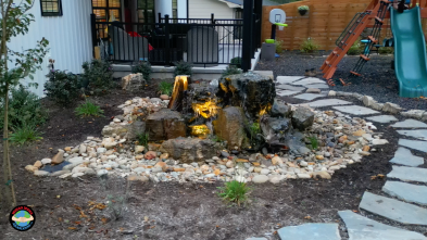 Backyard waterfall and stone path landscape
