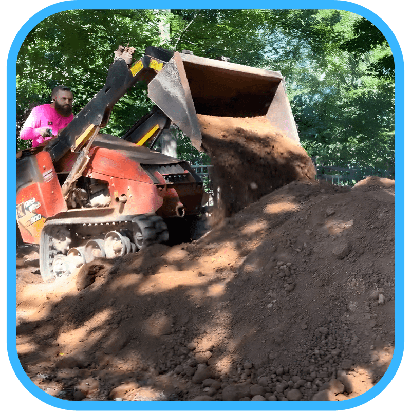 Mini-loader moving dirt during pond construction