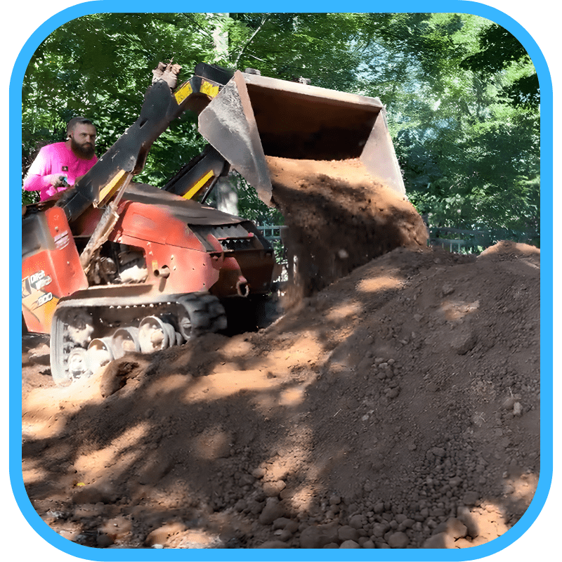 Excavator dumping dirt during pond construction