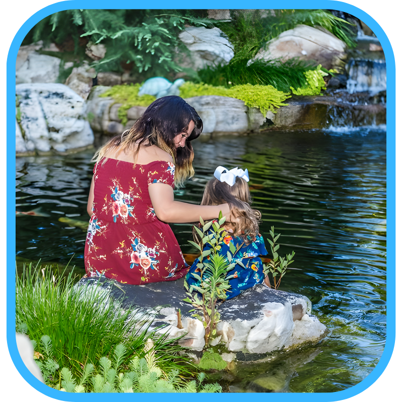 Mother and daughter enjoying a well-maintained pond together